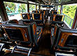 Interior picture of Vehicle Type 1017: 15 seater limousine bus with large comfortable  airline business-class style seats (big recline) and your own personal in-seat TV screen. 